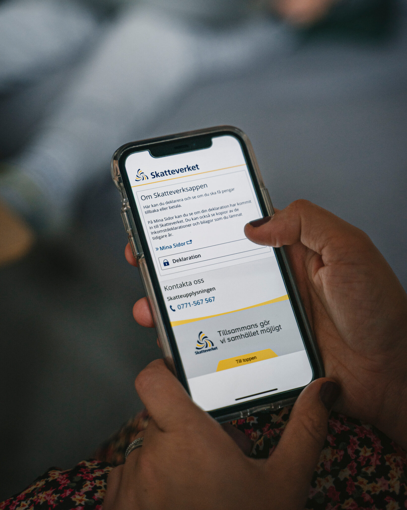 Someone holding a smartphone logged in to the Swedish tax agency
