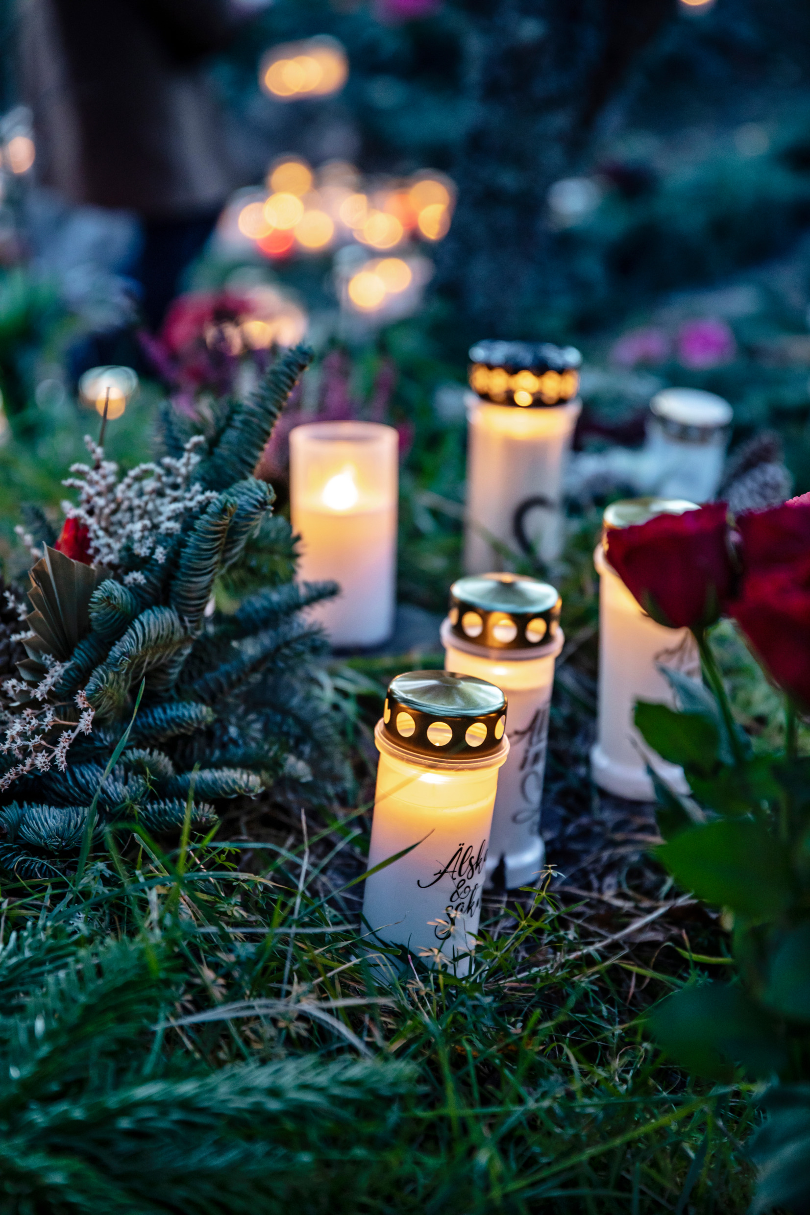 Lit candles on the ground.