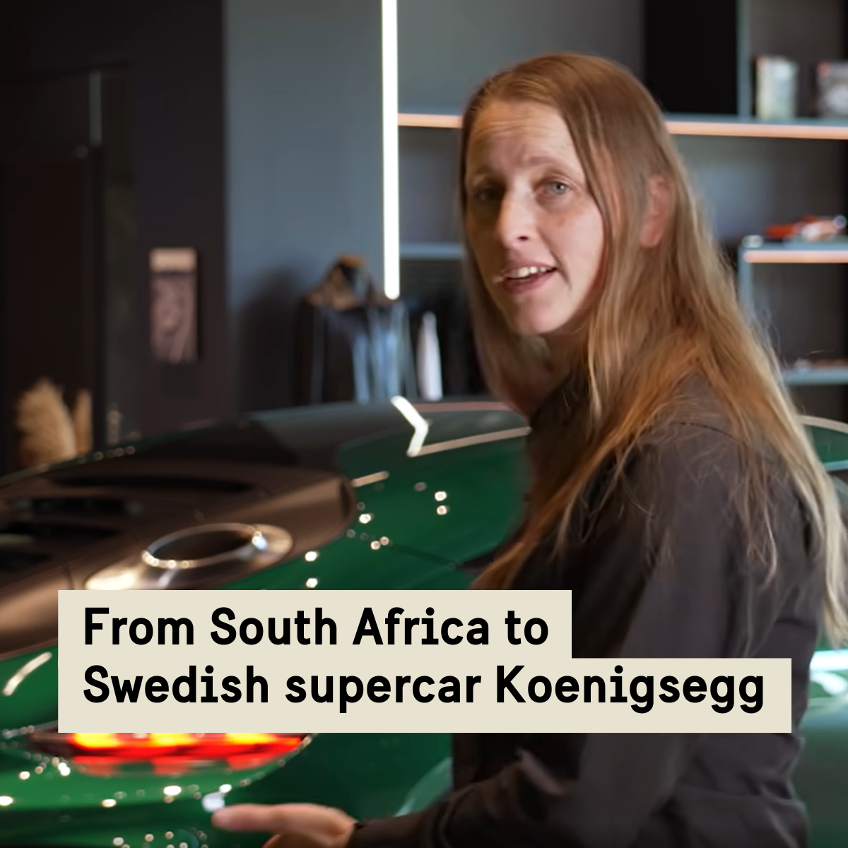 A woman in front of a sports car.