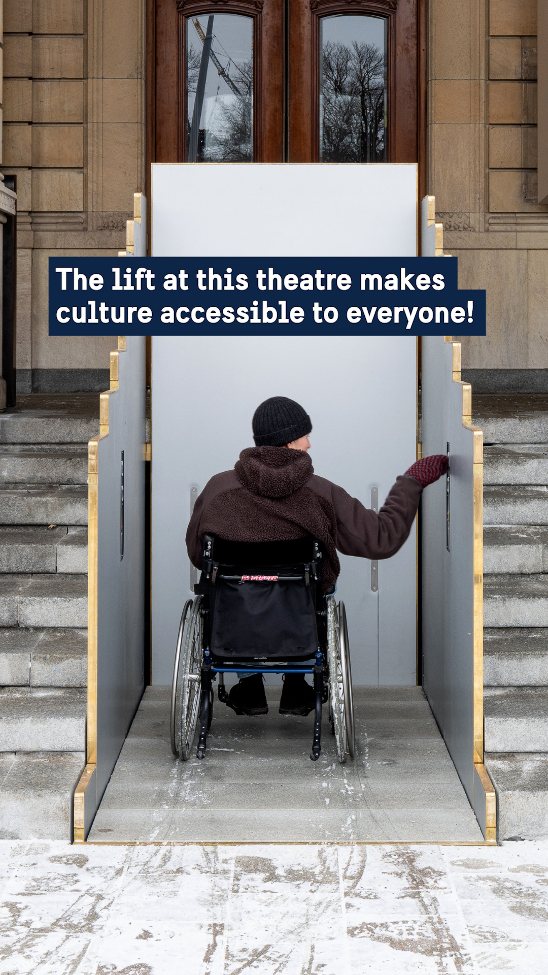 A person in a wheelchair getting on an outdoor stairlift.