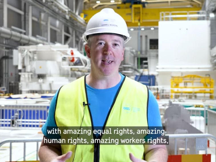 Man at a research center with a security vest and hat