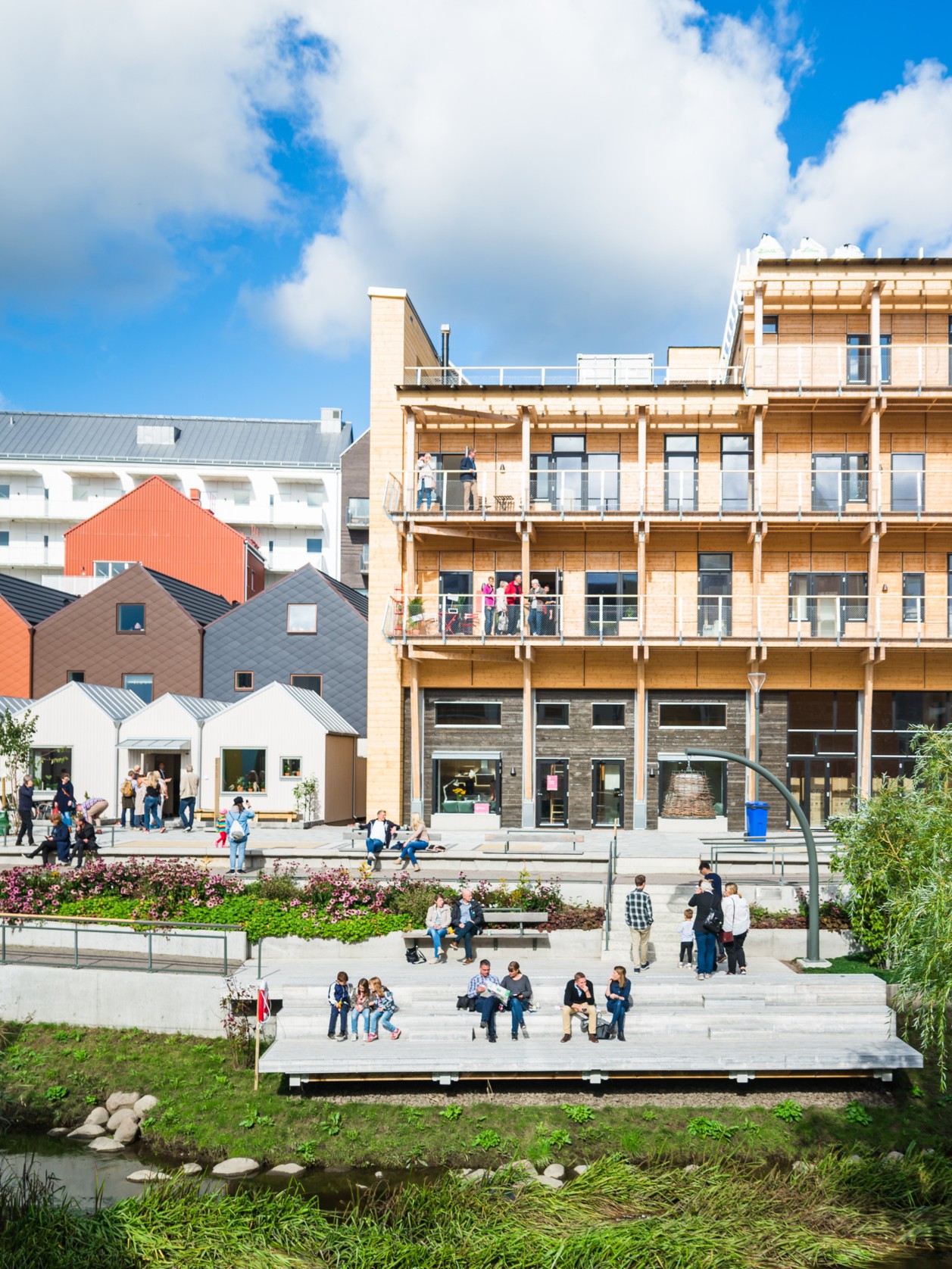 People sitting outside a housing complex